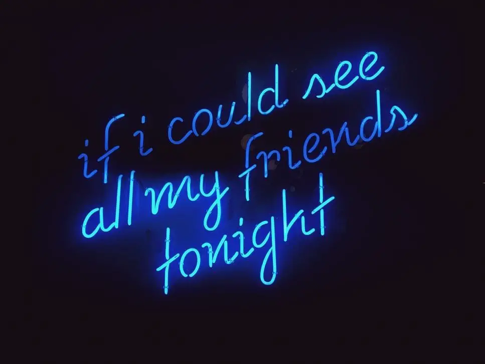 – A blue neon sign with a missing friends quote