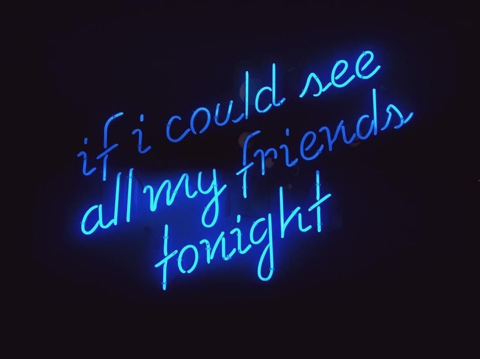 – A blue neon sign with a missing friends quote